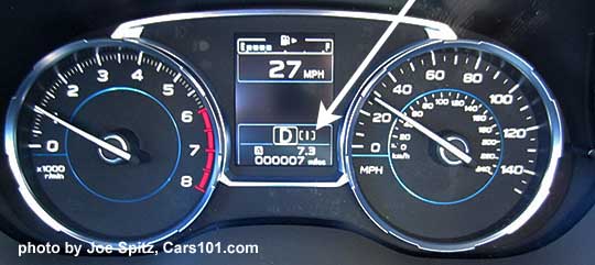 2018 and 2017 Subaru Forester 2.0XT Touring
                    dashboard gauges with white arrow pointing at the SI
                    Drive selection, to the right of the CVT position
                    indication
