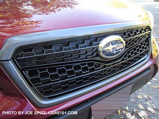 closeup of the 2018 and 2017 Subaru Forester optional Sport Grill with honeycomb center strip and center logo. Venetian red car shown