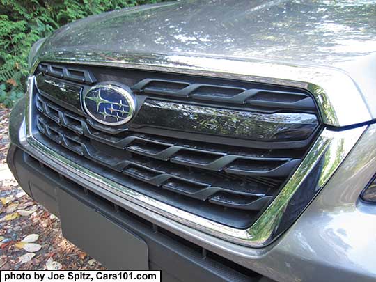 closeup of the 2017 Subaru Forester XT model front grill with gloss black center strip and center Subaru logo, on a Sepia Bronze car