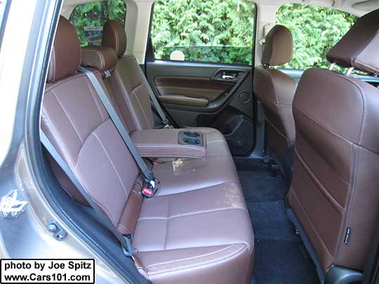 2018 and 2017 Subaru Forester Touring 2.5i and 2.0XT saddle brown leather trimmed rear seat showing the folding armrest with cupholders