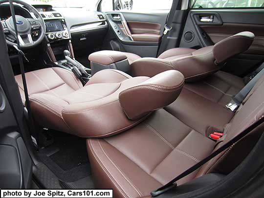 2018 and 2017 Subaru Forester front seats all the way reclined as flat as they will go resting against the rear seat. Saddle brown leather shown.