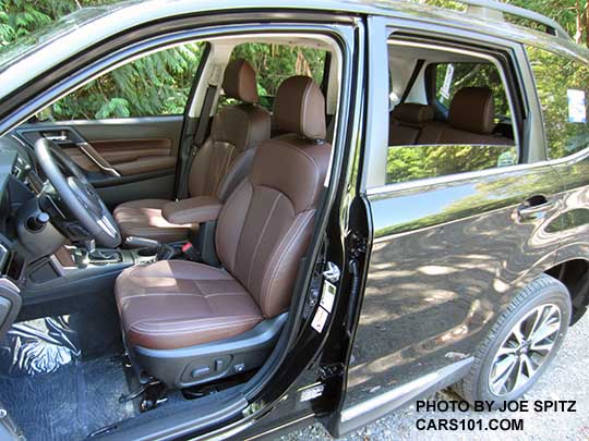 2018 and 2017 Subaru Forester Touring Saddle Brown front perforated leather trimmed seats in a dark gray car.