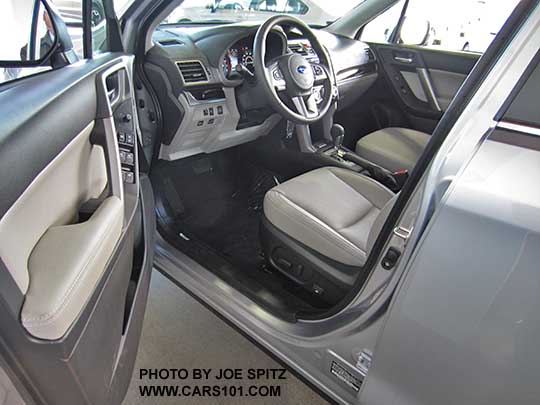 2017 Subaru Forester 2.5 Limited driver door and front seat. Platinum gray leather trimmed interior shown, ice silver car.