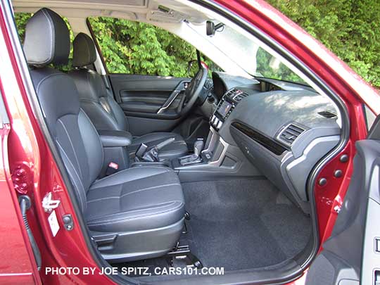 2017 Subaru Forester Touring black leather interior with gloss black dash and shift trim, and leather center console storage trim