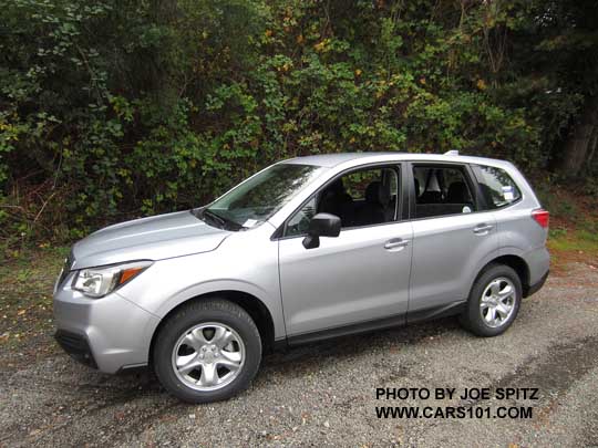 ice silver 2017 Subaru Forester 2.5i base model, has steel wheels, black unpainted outside mirrors, no dark tinted windows, no roof rails