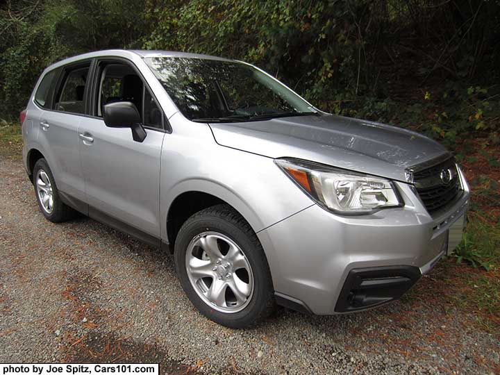 2017 Ice silver Subaru Forester 2.5i base model, has steel wheels, no dark tinted windows, no roof rails, black unpainted outside mirrors