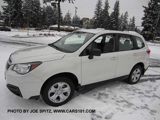 2018 and 2017 Subaru Forester 2.5i base model, steel wheels, no roof rails or dark tinted rear windows. Color white shown.