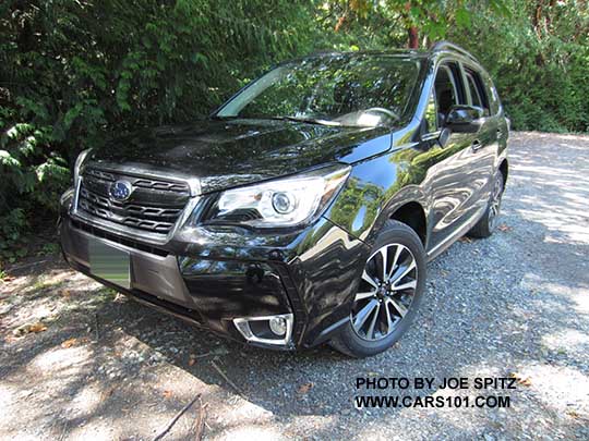 2017 Subaru Forester 2.0XT Touring turbo with Redesigned 2.0XT grill has a gloss black center strip and center logo, 18" black and silver 5 split spoke alloys. Crystal black shown.
