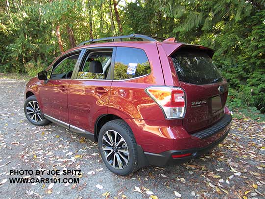 2017 Subaru Forester 2.0XT Touring with chrome rocker panel trim, dark rear glass, body colored rear spoiler.  Redesigned XT model 18" split-spoke black and silver alloys,  Venetian Red shown.