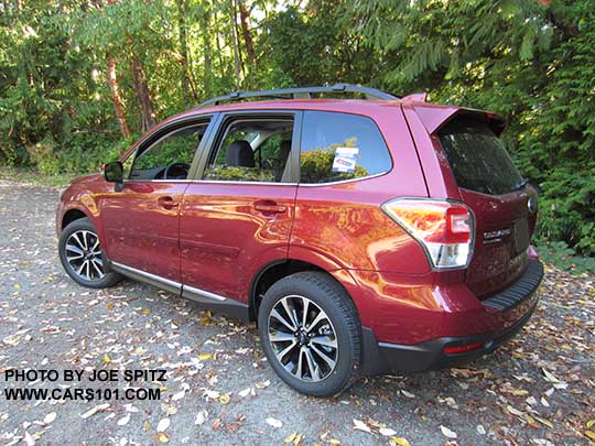 2018 and 2017 Subaru Forester 2.0XT Touring with chrome rocker panel trim, dark rear glass, body colored rear spoiler.  Redesigned XT model 18" split-spoke black and silver alloys,  Venetian Red shown.