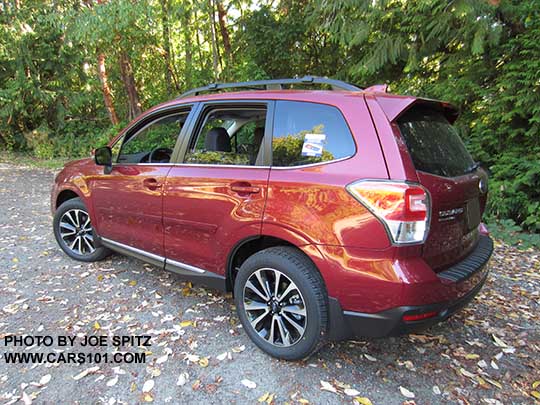 2017 Subaru Forester 2.0XT Touring with chrome rocker panel trim, dark rear glass, body colored rear spoiler.  Redesigned XT model 18" split-spoke black and silver alloys,  Venetian Red shown.