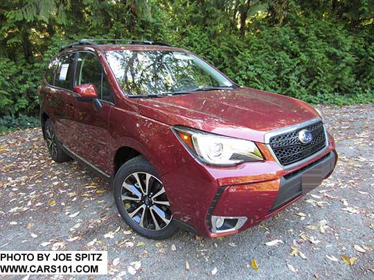 2018 and 2017 Subaru Forester 2.0XT Touring with chrome rocker panel trim and fog light trim, dark rear glass.  Redesigned XT model 18" split-spoke black and silver alloys and with honeycomb center strip and center logo.  Venetian Red shown. Optional aero cross bars.