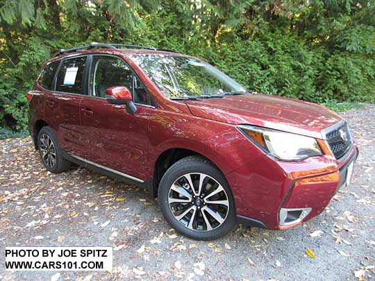 2018 and 2017 Subaru Forester 2.0XT Touring with chrome rocker panel trim and fog light trim, dark rear glass.  Redesigned XT model 18" split-spoke black and silver alloys. Optional Sport Grill with honeycomb center strip and center logo.  Venetian Red shown.