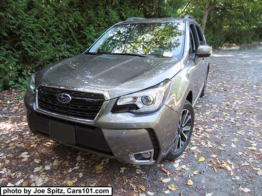 2018 and 2017 Forester 2.0XT Touring with chrome rocker panel trim. Sepia Bronze Metallic color shown. XT model front grill with gloss black center strip and center logo, 18" black and silver 5 split-spoke alloy wheels, steering responsive headlights