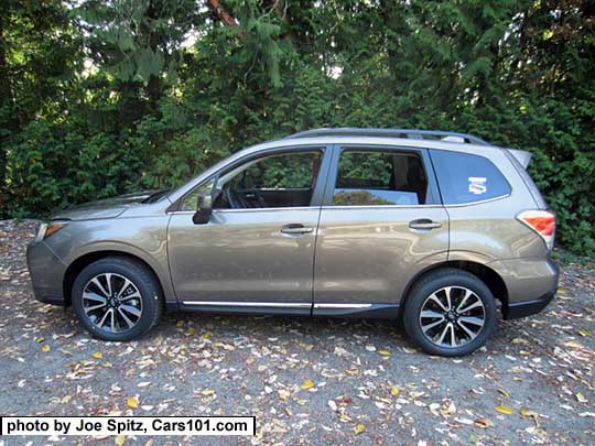 2017 Forester 2.0XT Touring with rear spoiler, chrome rocker panel trim, dark tinted rear glass. Sepia Bronze Metallic color shown. XT model shown with 18" black and silver 5 split-spoke alloy wheels