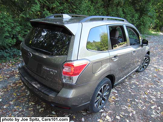 2018 and 2017 Forester 2.0XT Touring with rear spoiler, and chrome rocker panel strip. Sepia Bronze Metallic color shown. XT model has redesigned for 2017 18" black and silver 5 split-spoke alloy wheels. Optional rear bumper cover