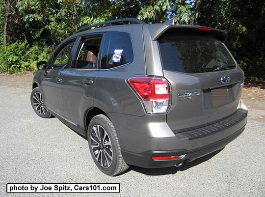 2018 and 2017 Forester 2.0XT Touring with rear spoiler, and chrome rocker panel strip. Sepia Bronze Metallic color shown. XT model has redesigned for 2017 18" black and silver 5 split-spoke alloy wheels. Optional rear bumper cover