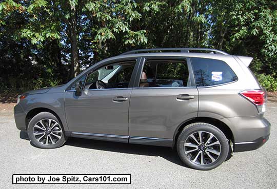 2017 Forester 2.0XT Touring with rear spoiler, dark tinted rear glass, and chrome rocker panel strip. Sepia Bronze Metallic color shown. XT model has redesigned for 2017 18" black and silver 5 split-spoke alloy wheels