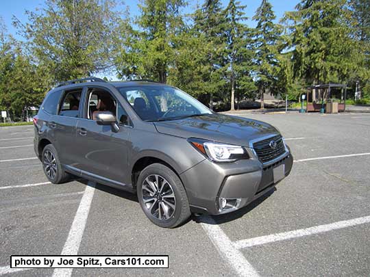 2018 and 2017 Forester 2.0XT Touring with dark tinted rear glass, and chrome rocker panel strip and fog light trim. Sepia Bronze Metallic color shown. XT model has redesigned for 2017 blacked-out front grill and 18" black and silver 5 split-spoke alloy wheels
