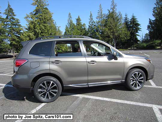 2018 and 2017 Forester 2.0XT Touring with dark tinted rear glass, rear spoiler, and chrome rocker panel strip. Sepia Bronze Metallic color shown. XT model has redesigned for 2017 18" black and silver 5 split-spoke alloy wheels