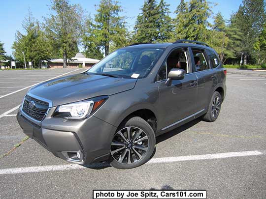 2018 and 2017 Forester 2.0XT Touring with dark tinted rear glass, chrome rocker panel strip and fog lights trim. Sepia Bronze Metallic color shown. XT model has redesigned for 2017 grill has a gloss black center strip and center logo, and 18" black and silver 5 split-spoke alloy wheels