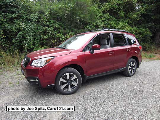 2018 and 2017 Subaru Forester 2.5 Premium with redesigned 17" black/silver alloys and chrome foglight trim (no fog lights on this car). Venetian Red color shown. Optional aero cross bars.