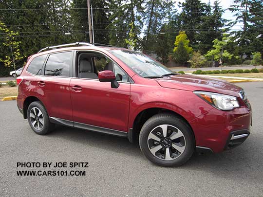 2018 and 2017 Forester 2.5 Premium with body colored outside mirrors, dark glass, roof rails, and new for 2017 black/silver 17" alloys, and chrome fog light trim. Optional aero cross bars shown. Venetian red Pearl.