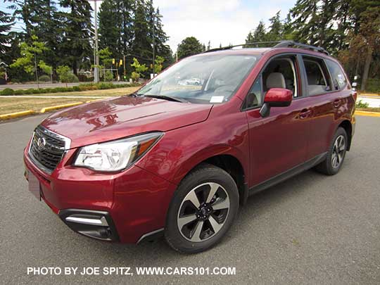 2018 and 2017 Forester 2.5 Premium with body colored outside mirrors, dark glass, roof rails, and new for 2017 black/silver 17" alloys, and chrome fog light trim. Optional aero cross bars shown. Venetian red Pearl.