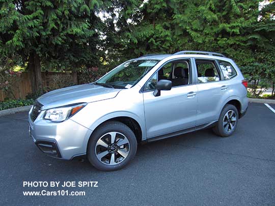 2018 and 2017 Subaru Forester 2.5 base model has black outside mirrors, black fog light trim (no chrome), no dark tinted windows, and no rear spoiler. Shown with optional Alloy Wheel/Roof Rail Package. Ice silver. Redesigned wheels for 2017