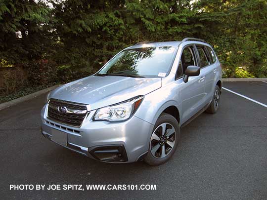 2017 ice silver Subaru Forester 2.5 base model has black outside mirrors and and fog light trim (no chrome fog light trim). Shown with optional Alloy Wheel/Roof Rail Package, ice silver. Redesigned wheels for 2017