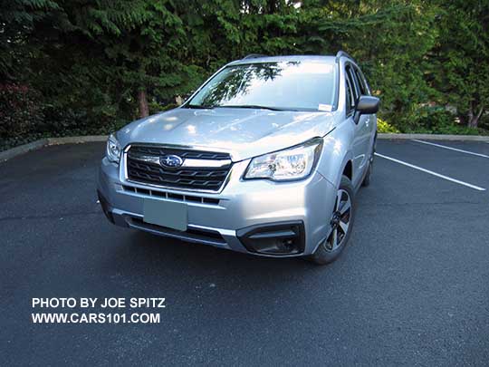 2018 and 2017 Subaru Forester 2.5 base model has black outside mirrors and black fog light trim (no chrome). Shown with optional Alloy Wheel/Roof Rail Package. Redesigned wheels for 2017. Ice silver shown.