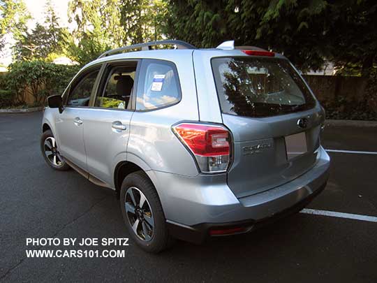 2017 Subaru Forester 2.5 base model has lightly tinted rear windows, and no rear spoiler (all other models have a rear spoiler). Shown with optional Alloy Wheel/Roof Rail Package, ice silver. Redesigned wheels for 2017