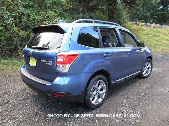 2017 Subaru Forester 2.5i Touring, 18" brushed silver wheels, quartz blue color shown. Optional rear bumper cover.