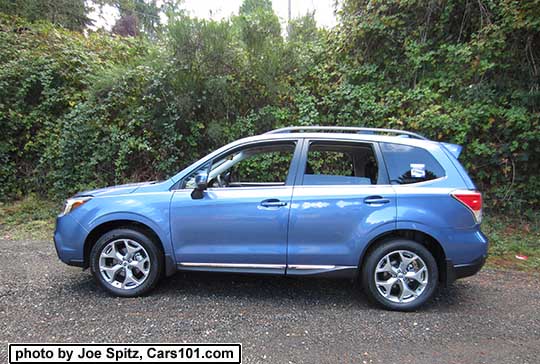 2017 Subaru Forester 2.5i Touring, 18" brushed silver wheels, chrome rocker panel trim. quartz blue color shown.