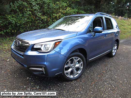 2018 and 2017 Subaru Forester 2.5i Touring, 18" brushed silver wheels, chrome rocker panel trim. quartz blue color shown.