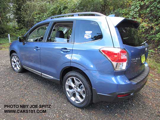 2018 and 2017 Subaru Forester 2.5i Touring, 18" brushed silver wheels, chrome rocker panel trim. quartz blue color shown.