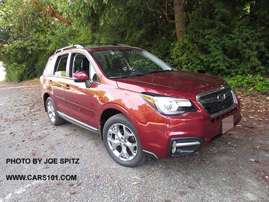 2018 and 2017 Subaru Forester 2.5i Touring has 18" brushed silver wheels, chrome rocker panel trim. Venetian red color shown.