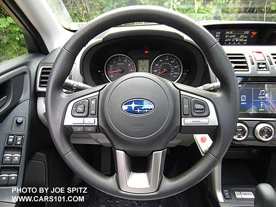 2017 Subaru Forester Premium vinyl coated steering wheel with audio, cell phone bluetooth, and cruise control. The 7" audio in the background indicates this is a Premium and not a 2.5i base model.