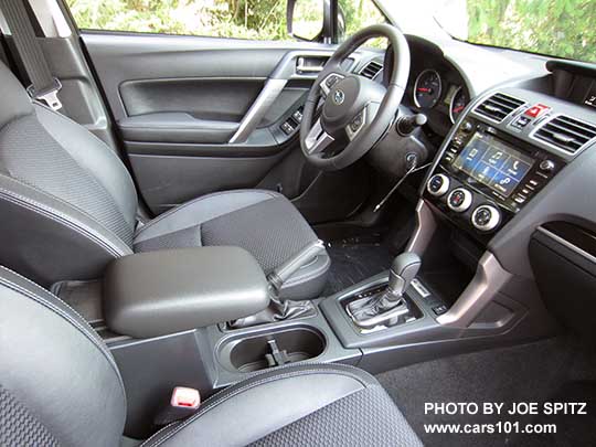 2018 Subaru Forester 2.5 Premium CVT 'Black Edition' black cloth interior with leatherette trim, CVT with gloss black trim, gloss black dash trim,  7" audio, sliding armrest pushed forward.   Also 2.0XT Premium interior.