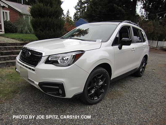 2018 Forester 2.5 Premium CVT Black Edition has black 18" alloys, black outside mirrors, black sport grill with chrome frame, fog lights. white car shown.