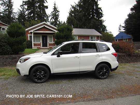 2018 Forester 2.5 Premium CVT Black Edition has black 18" alloys, black outside mirrors. side view, white car