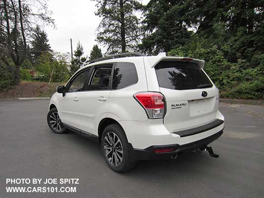 2018 Subaru Forester XT Touring rear view. White shown. Optional side moldings and trailer hitch.