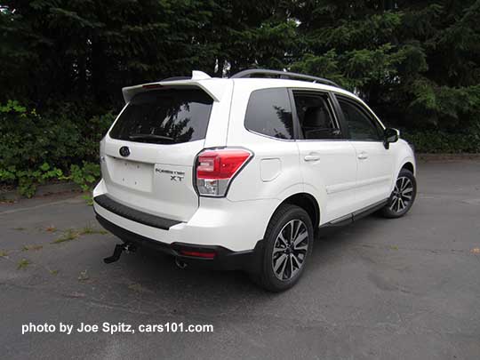 2018 Subaru Forester XT Touring rear view. White shown. Optional side moldings and trailer hitch.