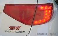 close-up of red painted tail-lights on Carl Bs white Subaru STI
