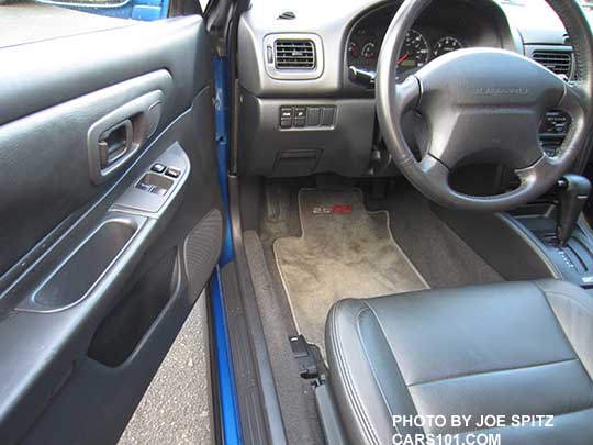 1998 Subaru Impreza drivers door panel, control buttons, steering wheel