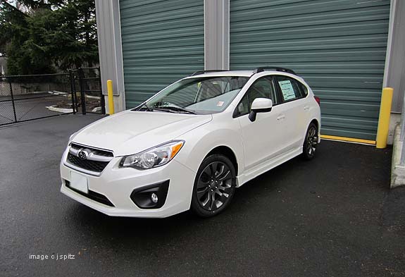 white subaru imporeza sport 5 door with roof rails