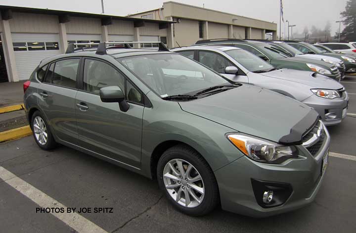 jasmine green subaru impreza 5 door with optional roof rack and front hood deflector