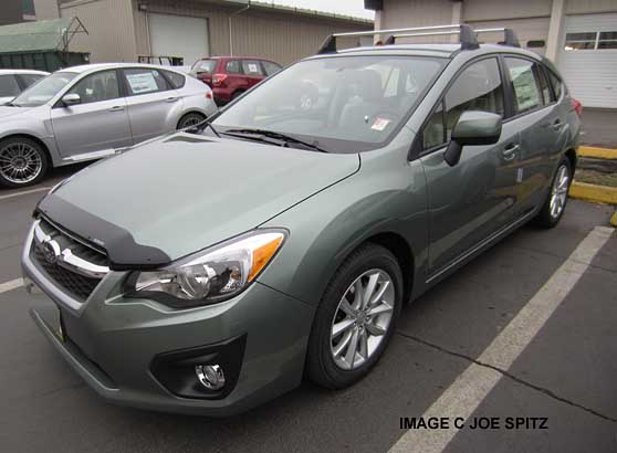Jasmine Green 5 door Impreza 2.0 hatchback with optional front hood protector and roof rack cross bars