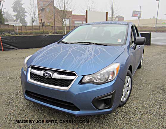 front of quartz blue 2014 subaru impreza sedan in the rain