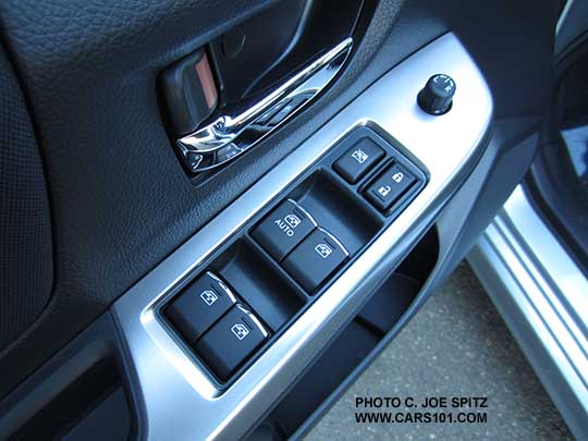 2015 Subaru Impreza Premium driver's door with bright inner door handle and bright trim tipped power window switches